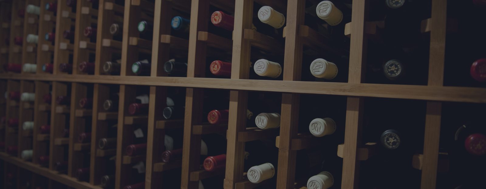 Wine bottles rest in a cellar that has been treated with professional wine organization from UOVO Wine.